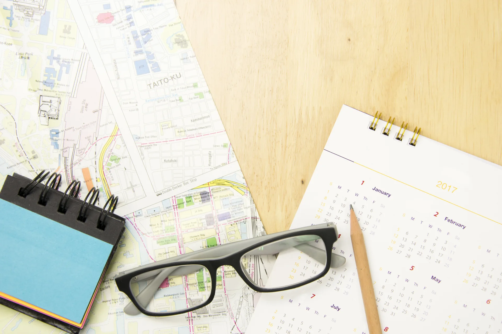 Calendario, mapa y anotador sobre una mesa para elegir la fecha del viaje